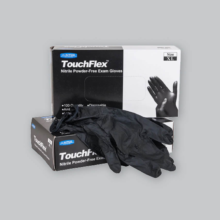 Pair of black nitrile gloves on top of black and white Touchflex boxes